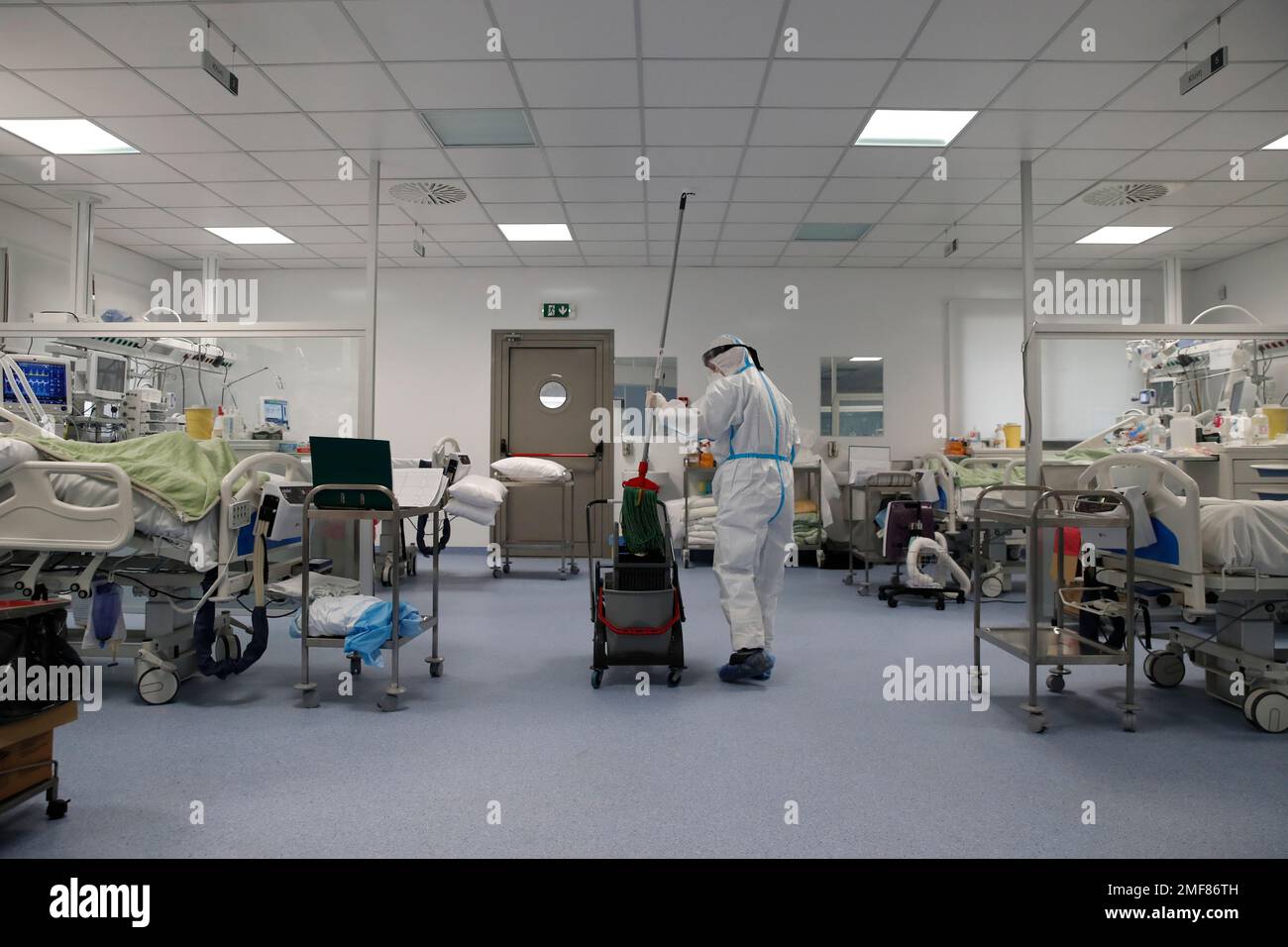 A cleaning worker mops the floor in an ICU of the Sotiria Thoracic