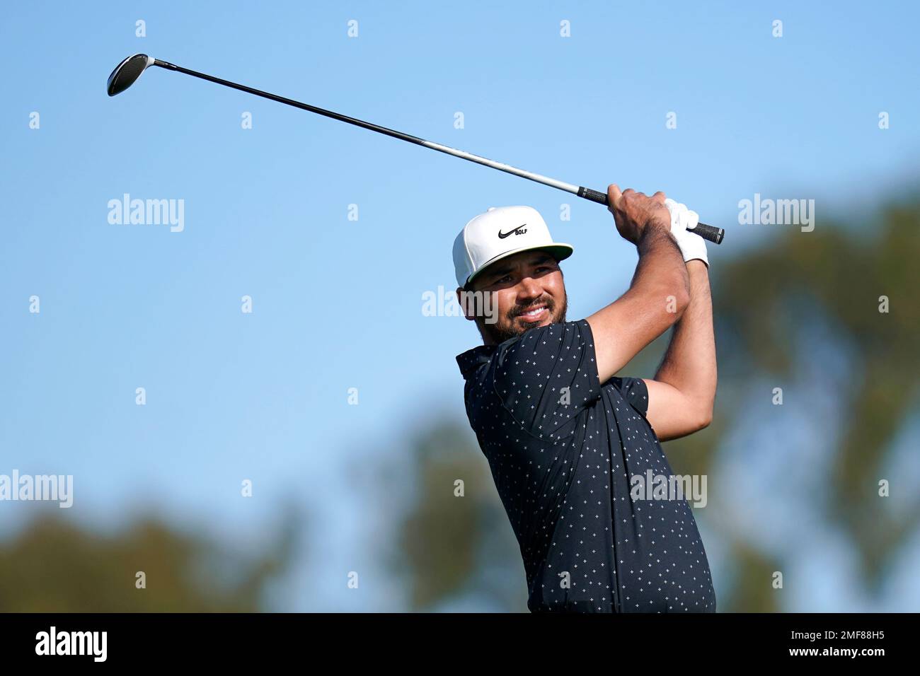 Jason Day, of Australia, follows through on a shot on the second hole