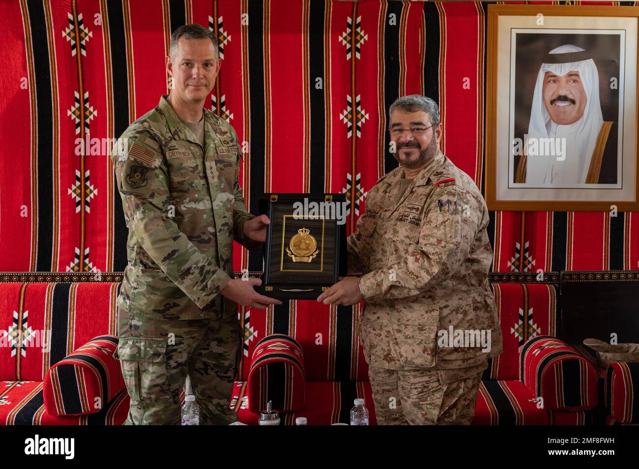 U.S. Air Force Lt. Gen. Alexus G. Grynkewich, left, Ninth Air Force (Air Forces Central) commander, receives a gift from Brig. Gen. Adel Al-Hafez, right, Kuwait Air Defense command chief, at the Kuwait Air Defense Headquarters, Aug. 17, 2022. During the visit, Grynkewich met with Kuwaiti military leaders to discuss the importance of resolute partnerships within the U.S. Central Command area of responsibility. Stock Photo