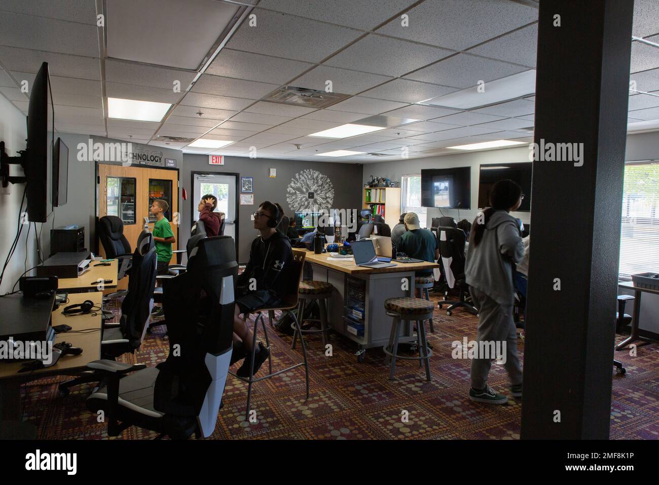 Youth use the Technology Room which has game computers, game consoles, and a robotics lab. Stock Photo