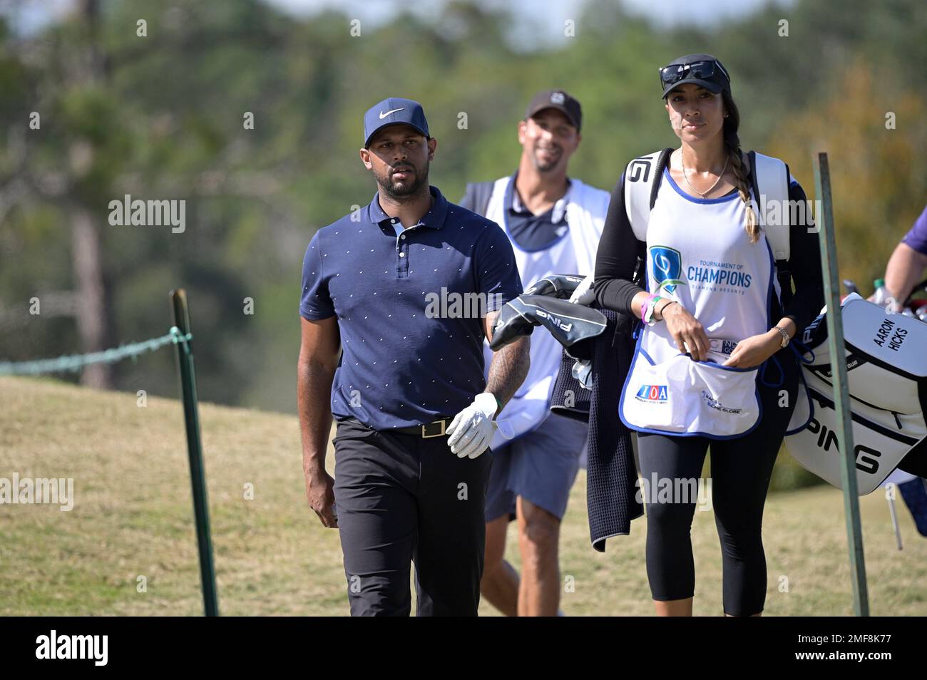 Professional baseball player Aaron Hicks, right, and his caddie Cheyenne  Woods, niece of golfer Tiger Woods, wait at the 17th tee during the final  round of the Tournament of Champions LPGA golf