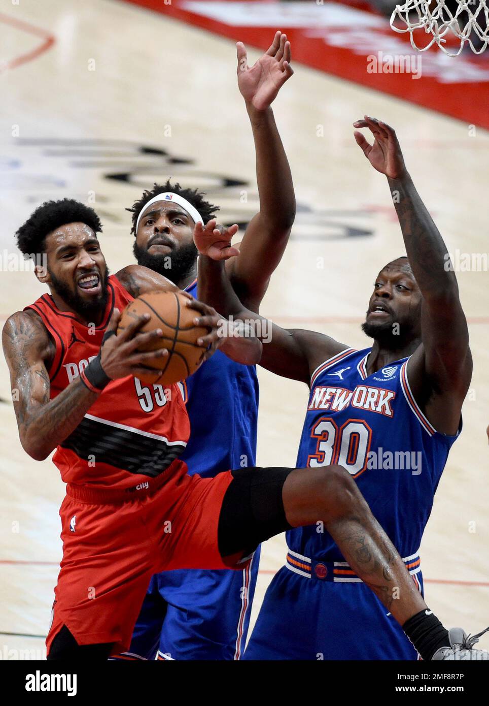 Portland Trail Blazers forward Derrick Jones Jr. left grabs a