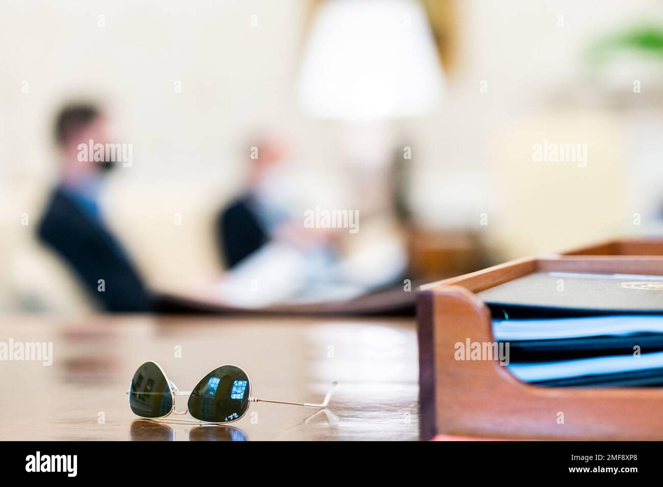 Reportage: President Biden's sunglasses are seen on the Resolute Desk during an infrastructure meeting with White House staff in the Oval Office of the White House Sunday, April 11, 2021 Stock Photo