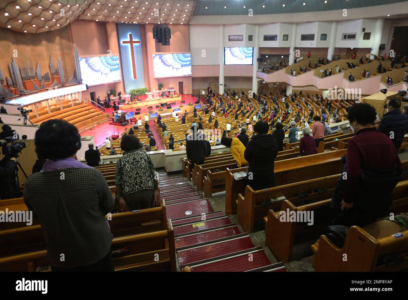 Christians attend a service while maintaining social distancing at the