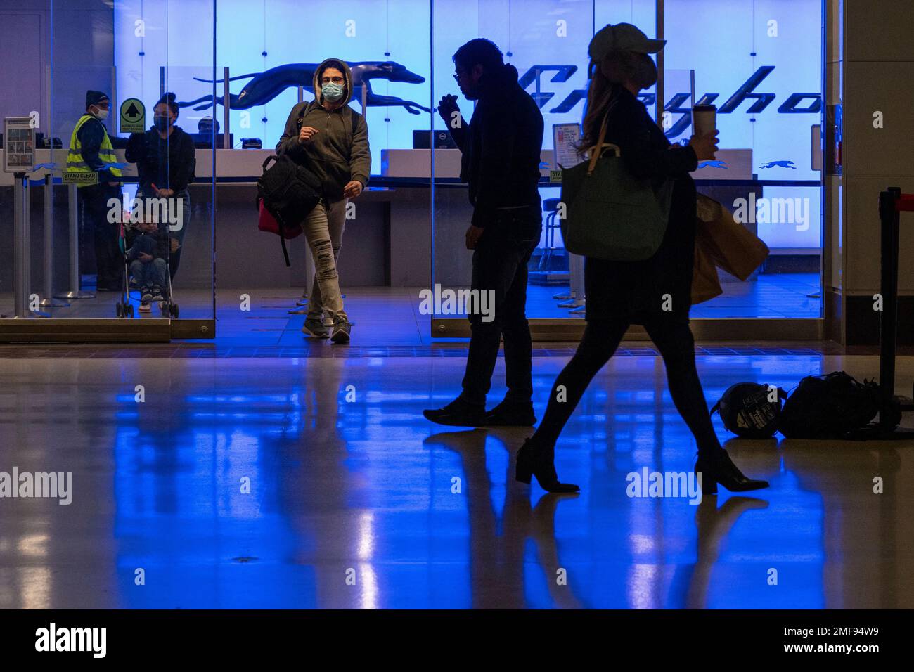 Commuters walk past the Greyhound ticket office at Port Authority Bus Terminal, Friday, Jan. 22