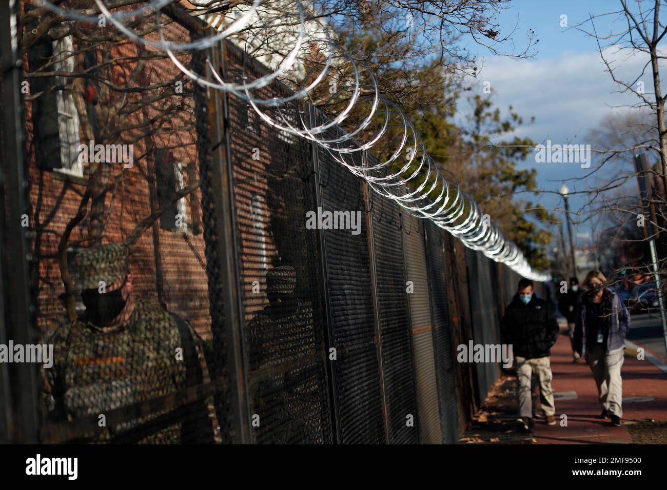 Innauguration Razor Wire National Guard troops walk behind security fencing and razor wire as ...