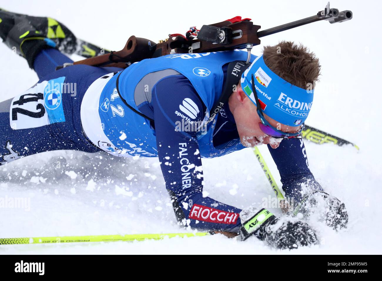 Fourth placed Lukas Hofer of Italy falls after crossing the finish line  during the men's 20km individual race at the Biathlon World Cup in  Anterselva, Italy, Friday, Jan. 22, 2021. (AP Photo/Matthias
