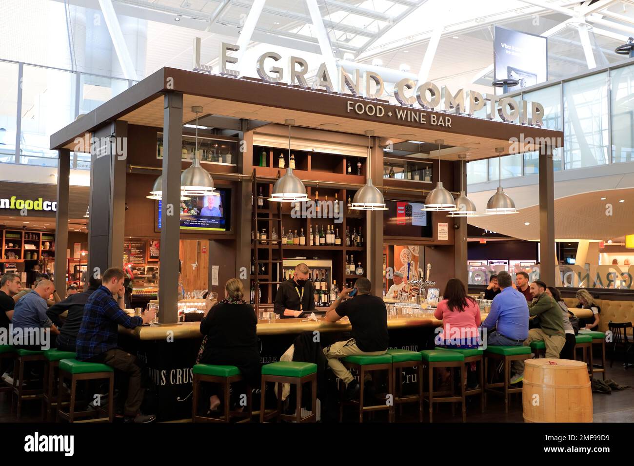 Le Grand Comptoir food and wine bar with customers inside the terminal of JFK International airport.New York City.New York.USA Stock Photo