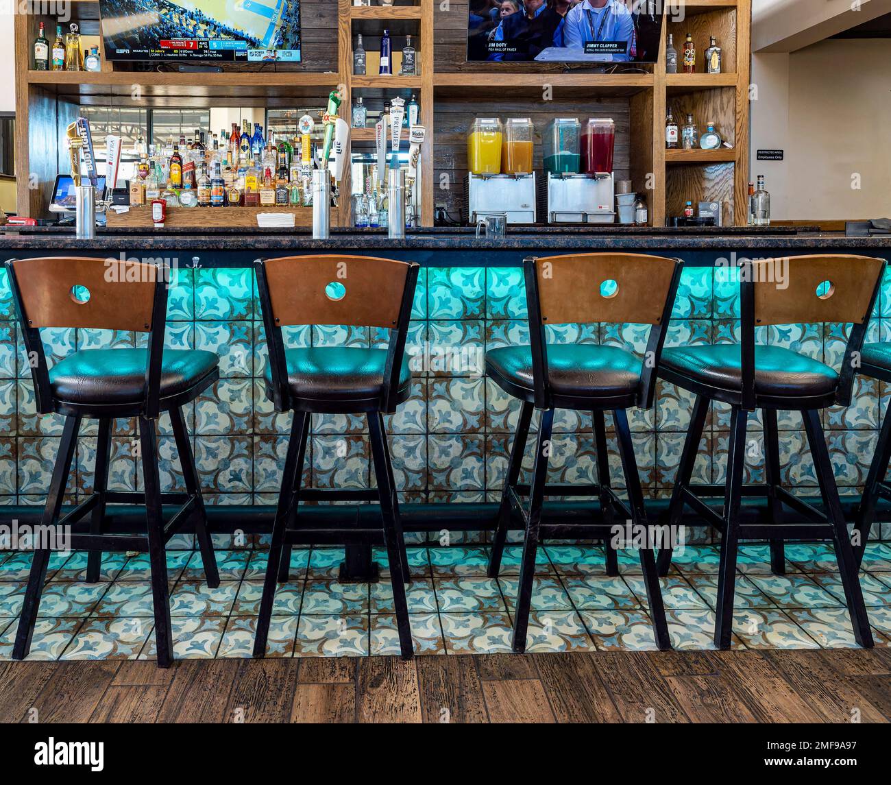 Empty barstools or chairs in a small restaurant bar or sports bar in Pike Road Alabama, USA. Stock Photo