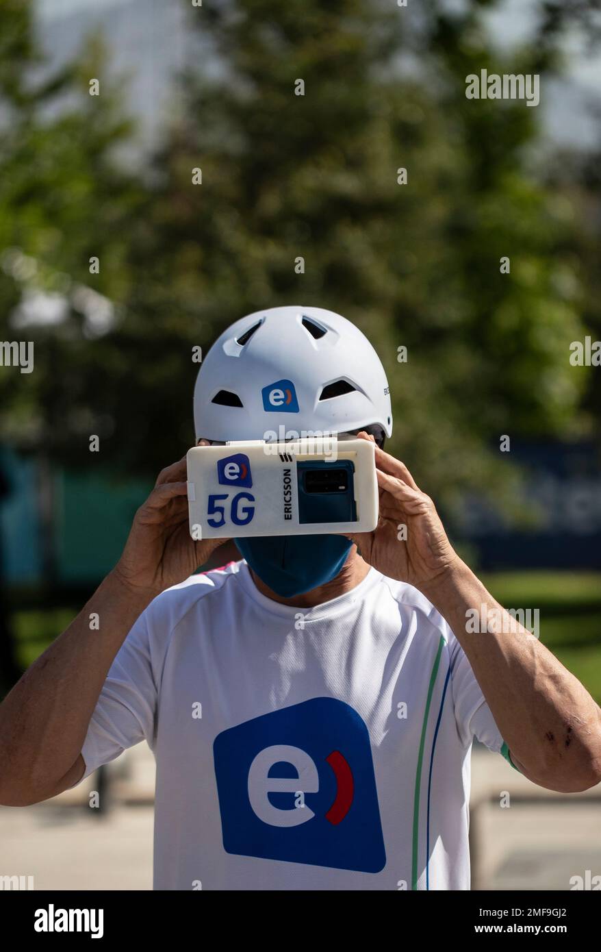 Sebastian Vasquez, a MTB downhill world tri-champion, demonstrates how he looks through goggles connected to a 5G network that is live-streaming video to him of what he aims is site at, before