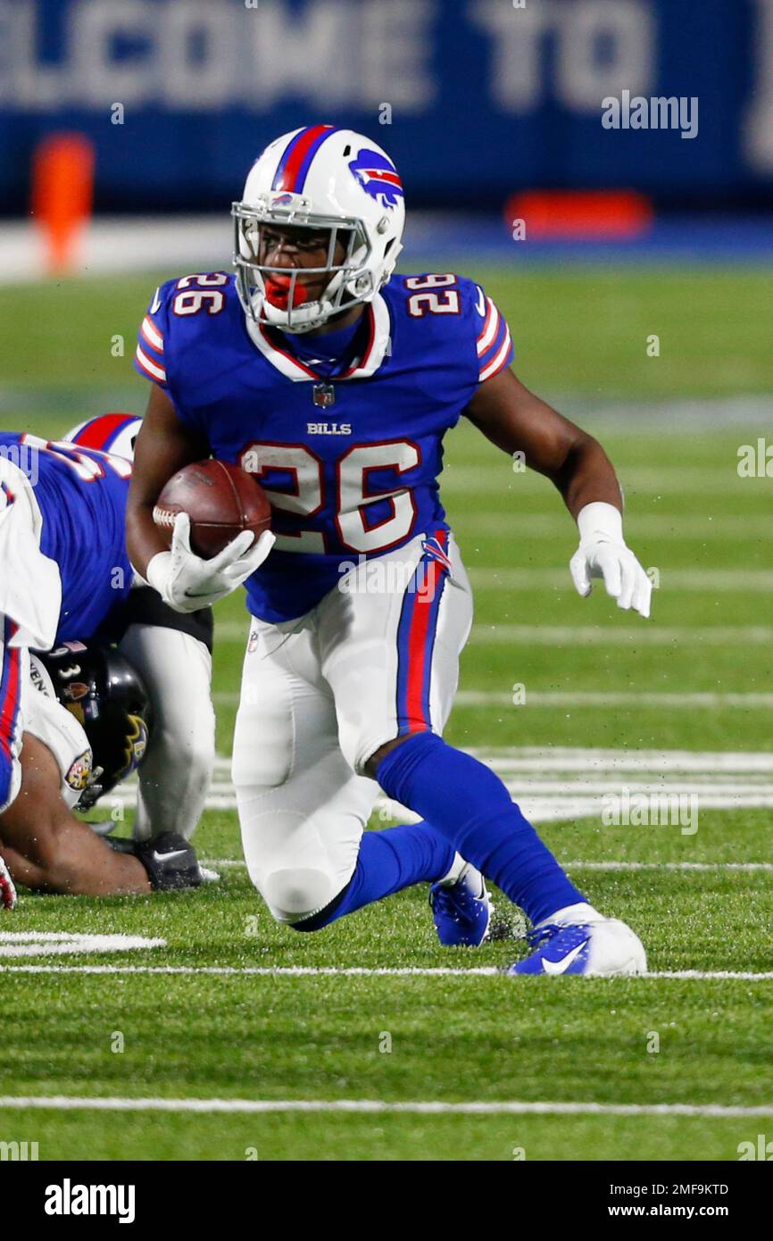 Buffalo Bills running back Devin Singletary (26) carries the ball during to  the first half of an NFL football game against the Baltimore Ravens in  Orchard park, N.Y., Saturday Jan. 16, 2021. (