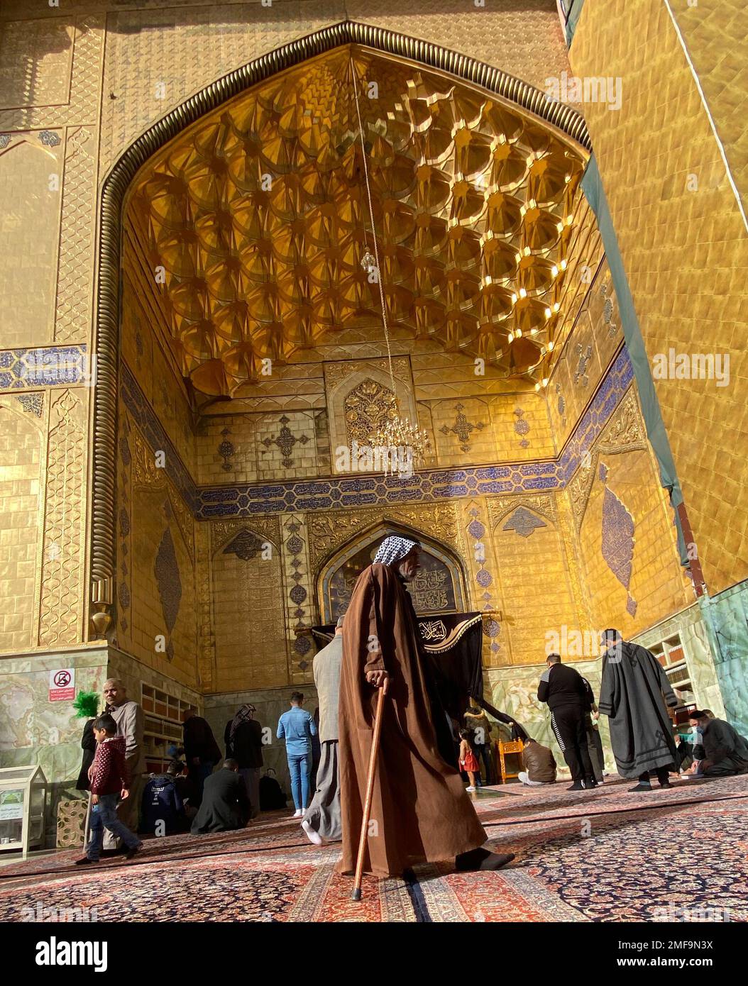 Shiite Muslim worshippers pray inside the holy shrine of Imam Ali, the