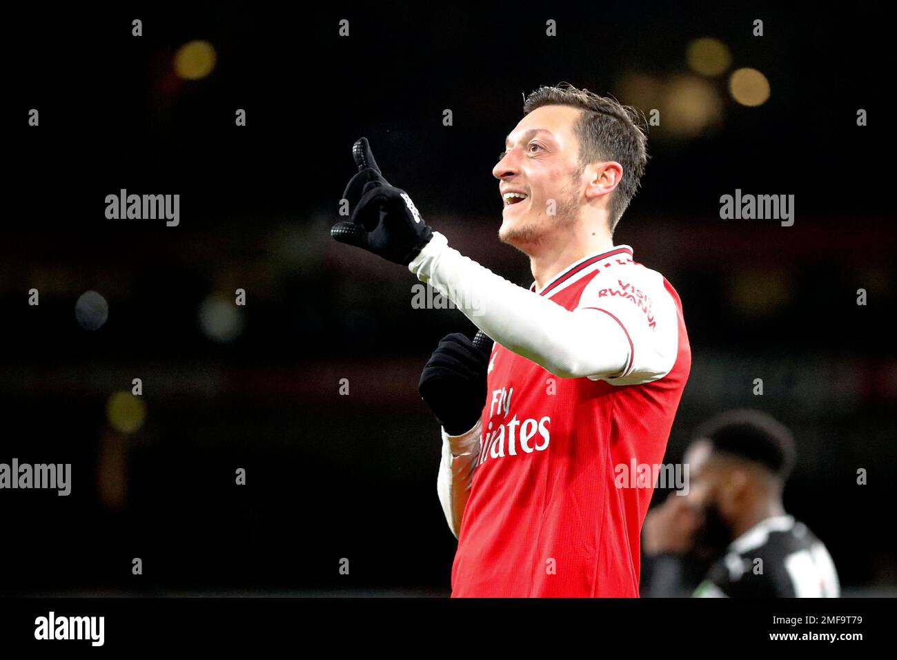 FILE - In this Sunday, Feb. 16, 2020 file photo, Arsenal's Mesut Ozil  celebrates after scoring his side's third goal during the English Premier  League soccer match between Arsenal and Newcastle at