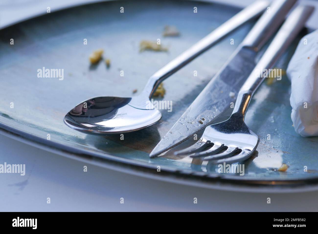 Empty plate after eating on table Stock Photo