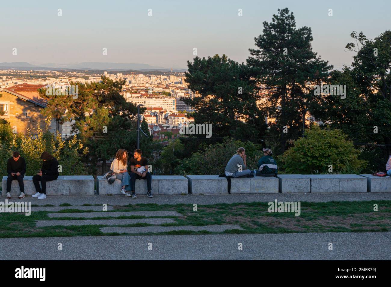 Couple at an overlook at golden light in the La Croix-Rousse district in Lyon Stock Photo