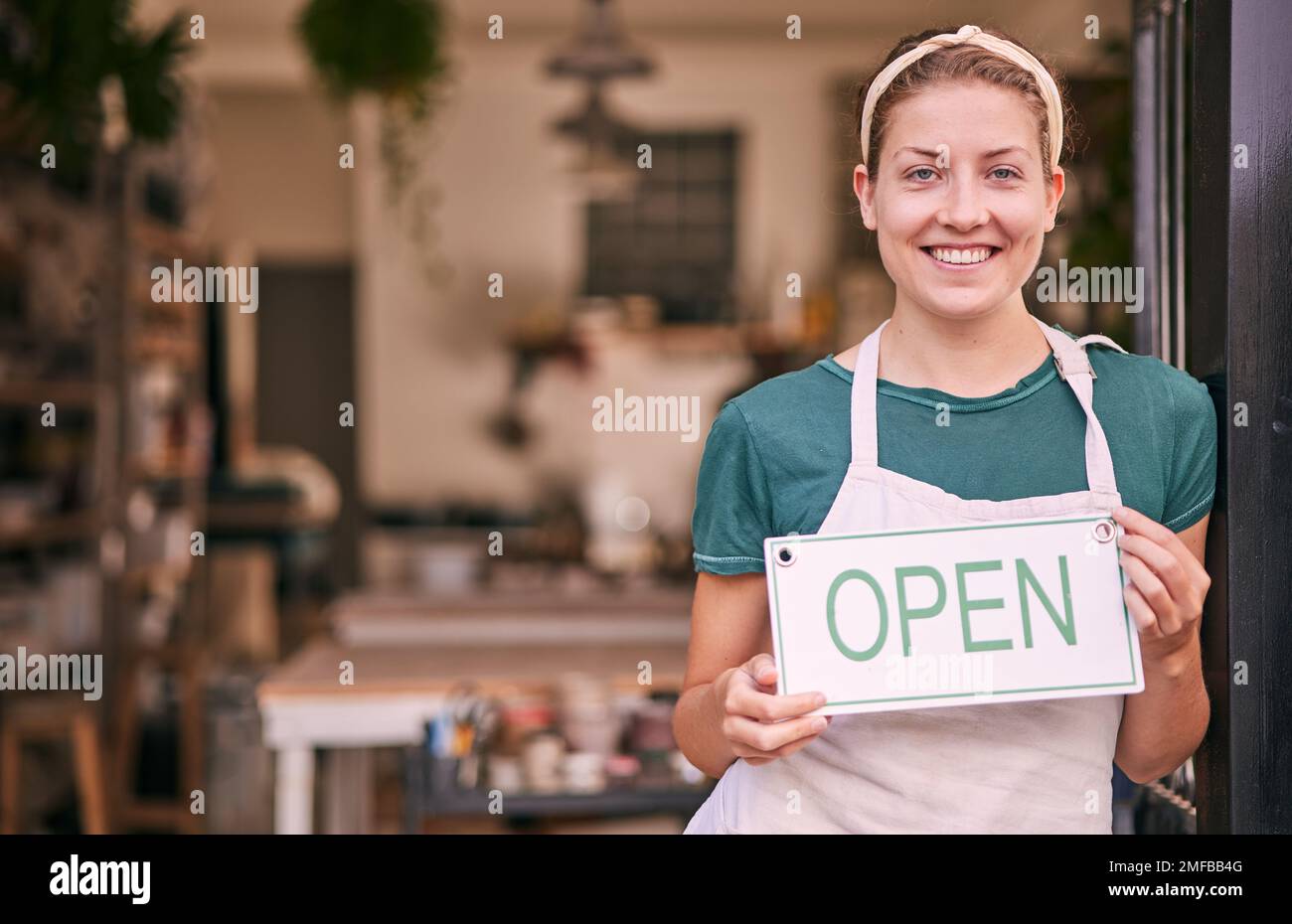 Woman, pottery and small business with open sign for creative startup, welcome or entrepreneurship at retail store. Portrait of happy shop owner with Stock Photo
