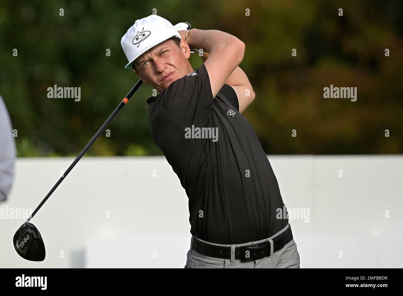 Daniel Trevino, son of golfer Lee Trevino, watches his tee shot on the
