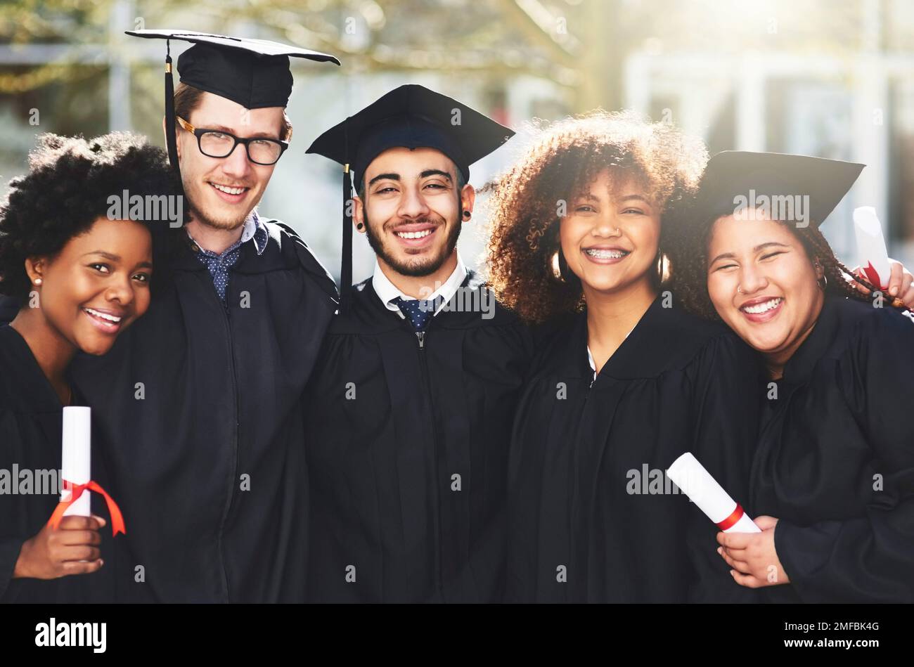 Our hard work paid off today. a group of students standing together on graduation day. Stock Photo
