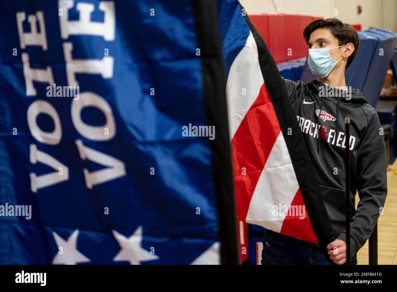 Thomas Hedrich sets up voting flags at a polling location in