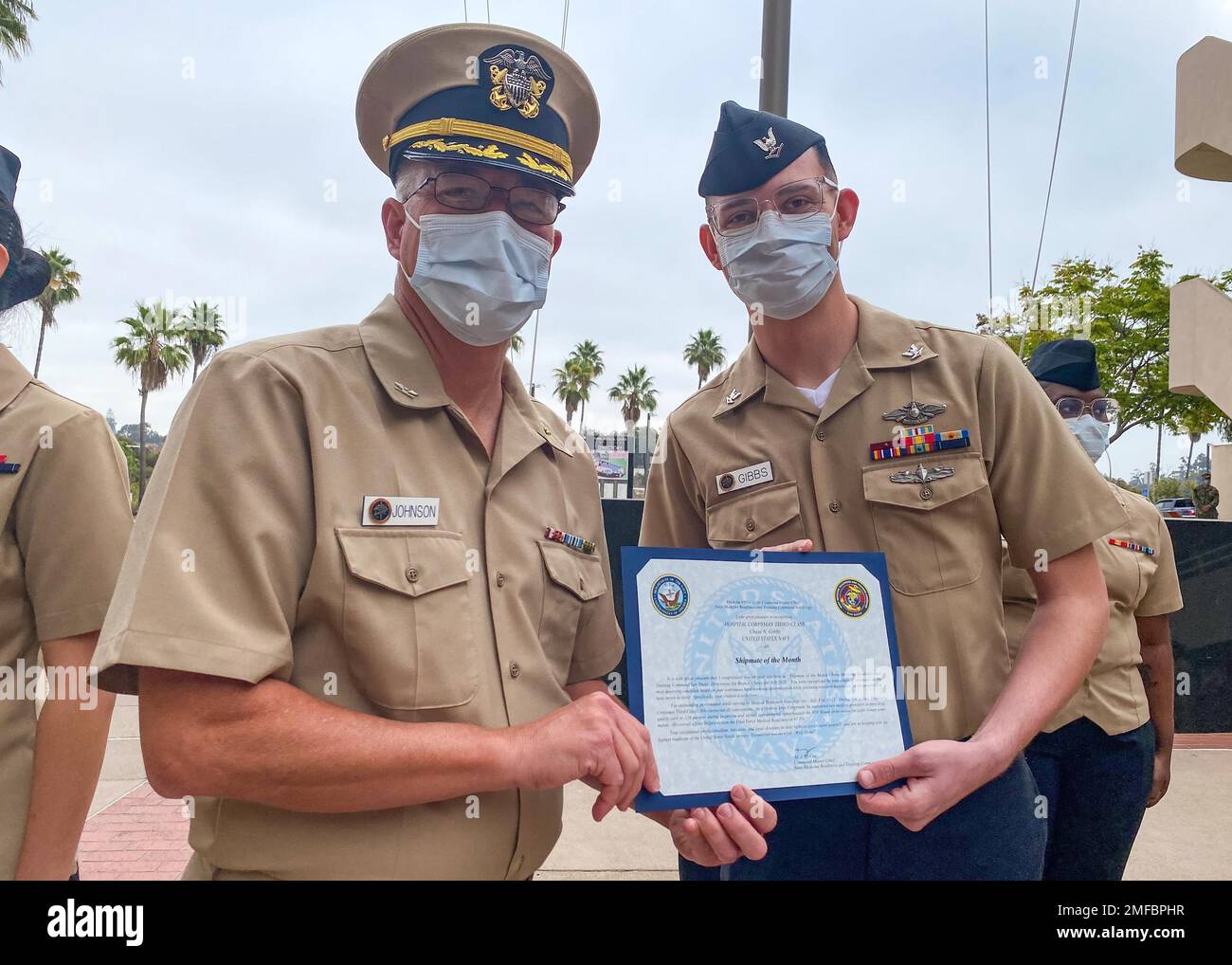 220819-N-XZ205-1009  SAN DIEGO (Aug. 19, 2022) Capt. Jeffery Johnson, Navy Medicine Readiness and Training Command (NMRTC) San Diego’s acting commanding officer (left), awards Hospital Corpsman 3rd Class Chase Gibbs, a Sailor assigned to NMRTC San Diego (right), with a Shipmate of the Month Award during a ceremony at the hospital Aug. 19. With input from NMRTC San Diego directorates’ chain of command, Shipmate of the Month honors Sailors who perform their duties exceptionally well. NMRTC San Diego's mission is to prepare service members to deploy in support of operational forces, deliver high Stock Photo