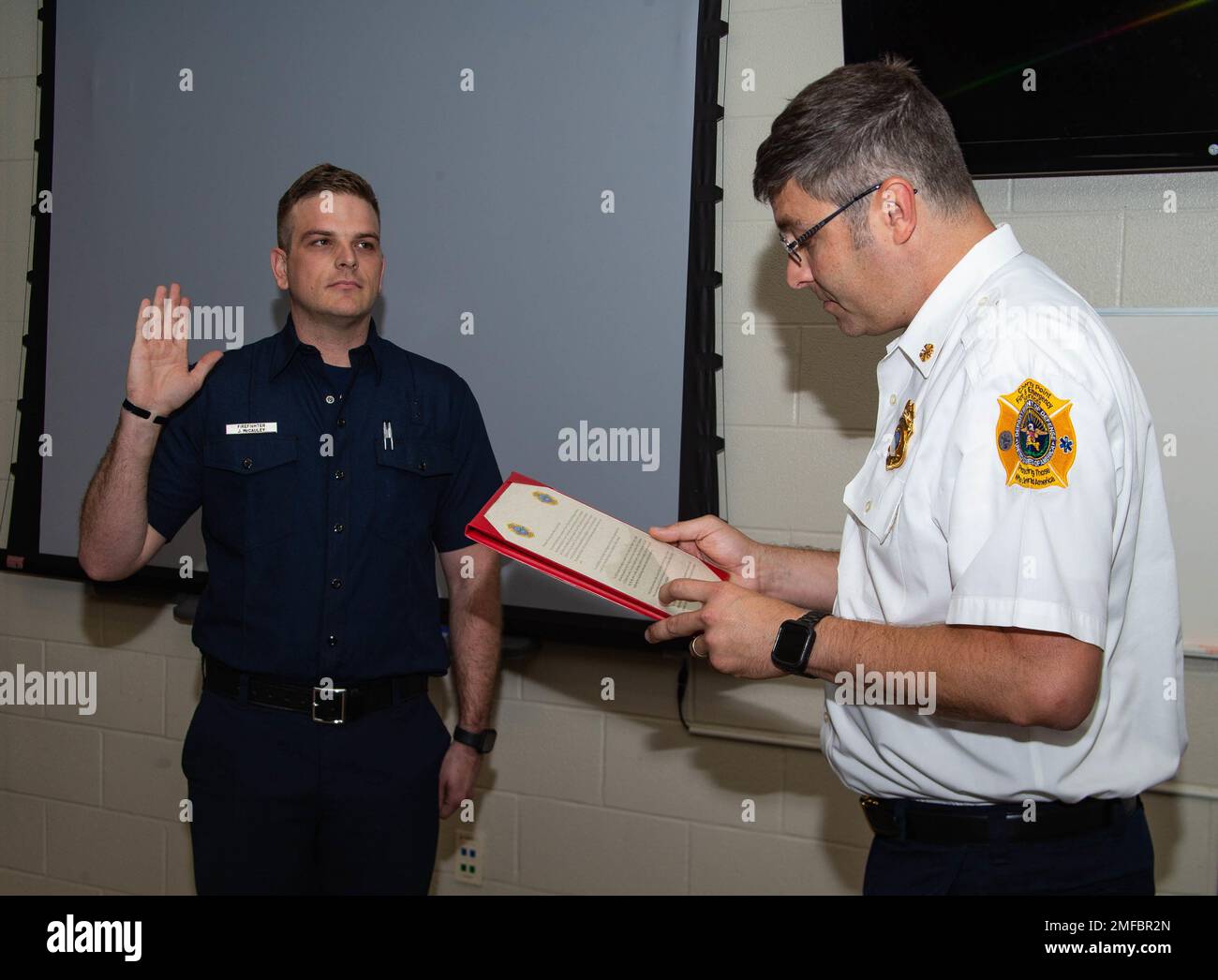 Jason R. McCauley, a firefighter on MCAS Cherry Point, swears in as a  firefighter during his pinning ceremony on MCAS Cherry Point, North  Carolina, Aug. 19, 2022. To become certified firefighters, trainees were put  through two sections of rigorous training that ensures only the most  qualified personnel are protecting the installation. Stock Photo