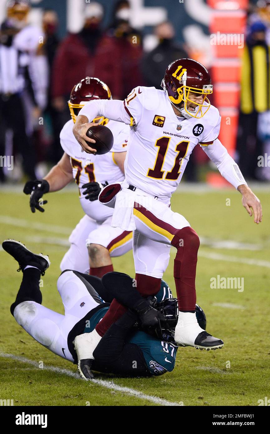 Washington Football Team's Alex Smith (11) is tackled by Philadelphia