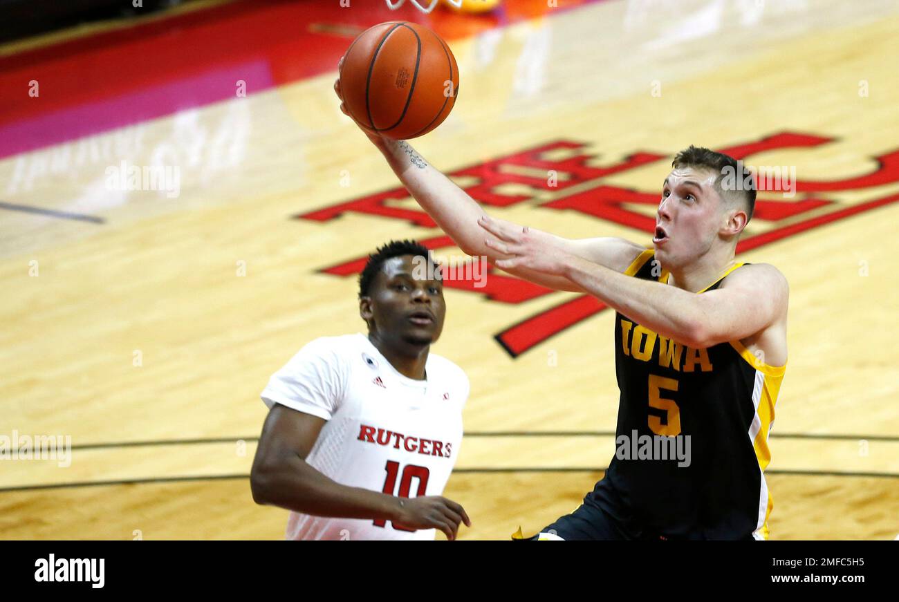 Iowa guard CJ Fredrick (5) goes to the basket against Rutgers guard