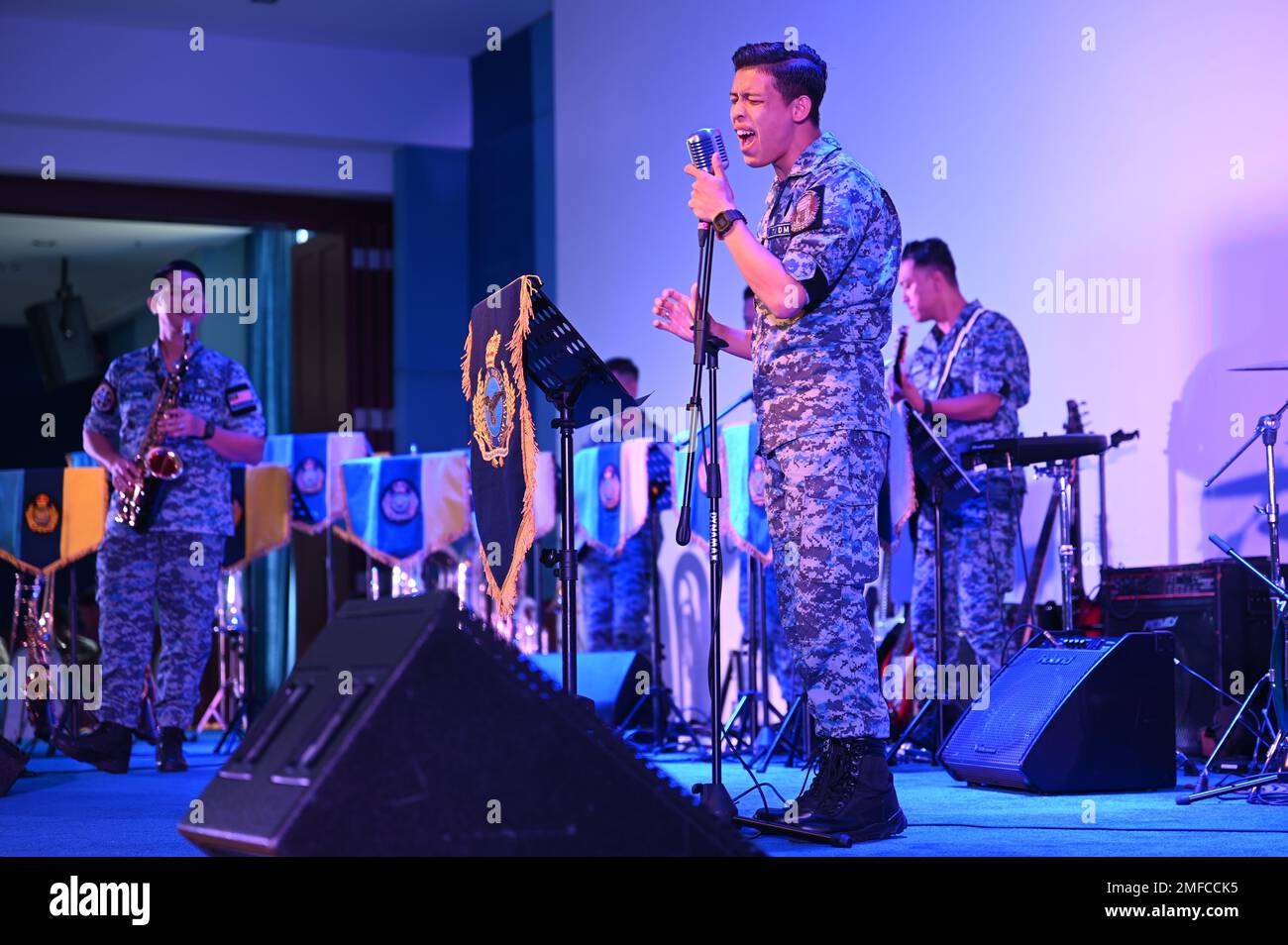 A vocalist with the Royal Malaysian Air Force sings on stage during the