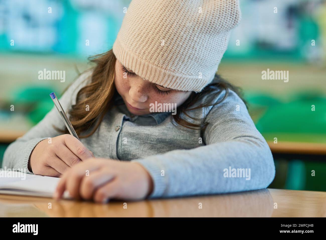 She knows all the answers to the test. an elementary school girl working in class. Stock Photo