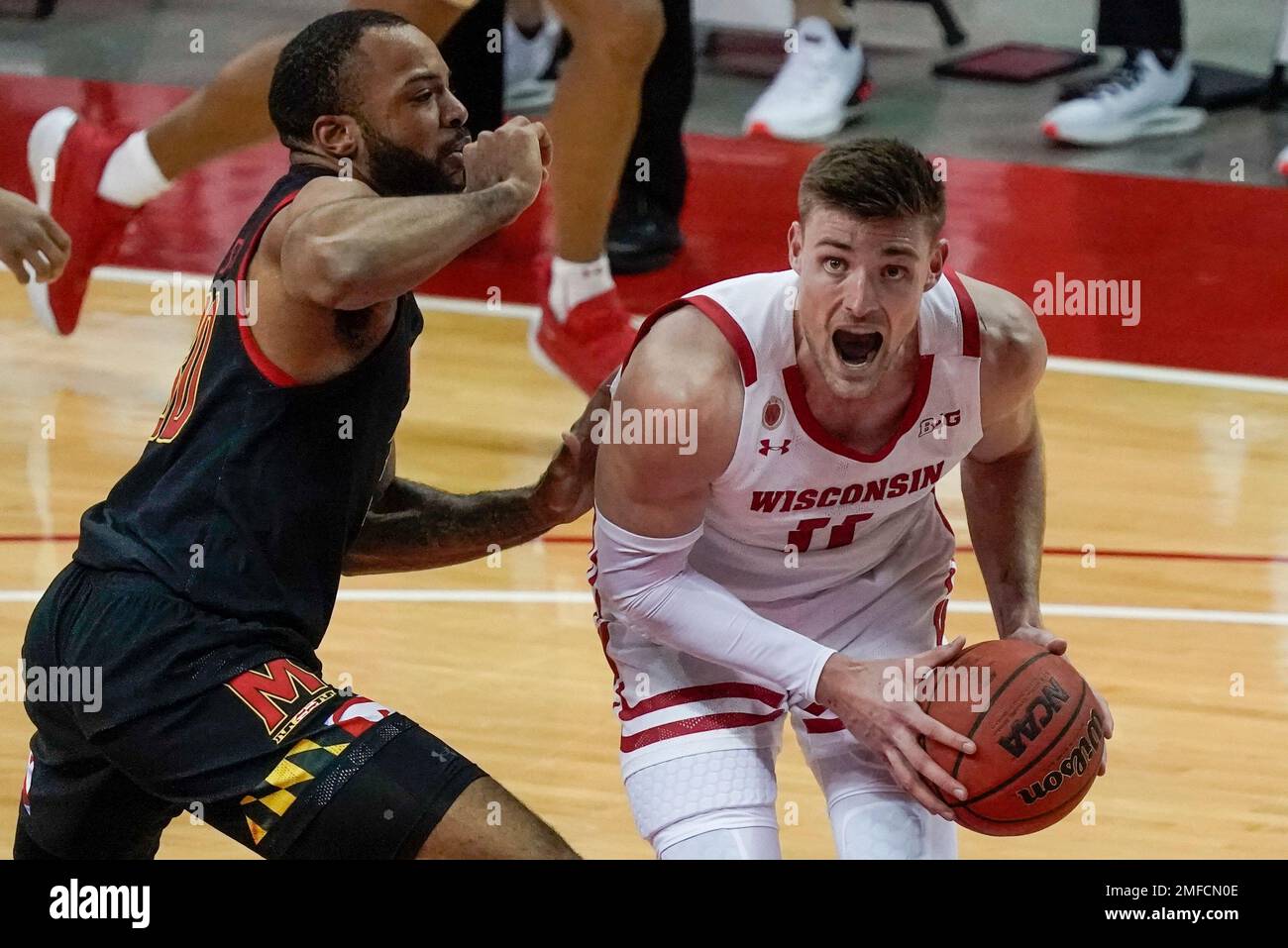 Wisconsin's Micah Potter tries to get past Maryland's Galin Smith