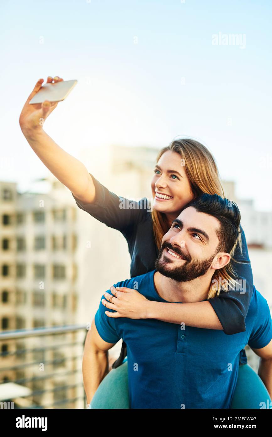 we-love-looking-back-at-selfies-a-young-couple-taking-a-selfie-outside