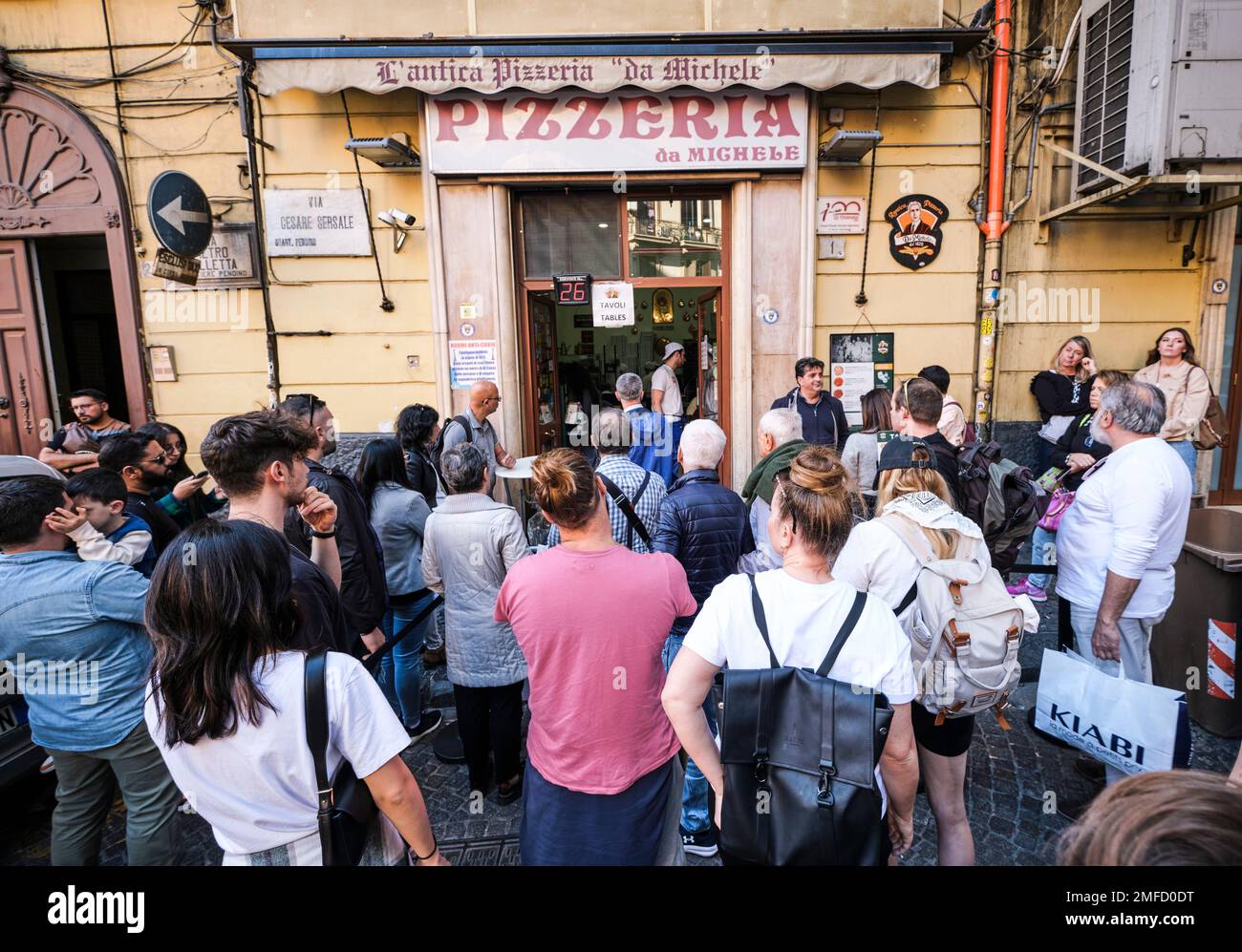 A crowd of people wait for a table at Pizzeria da Michele, made famous by the book, Eat, Pray, Love, by Elizabeth Gilbert. Julia Roberts starred in th Stock Photo