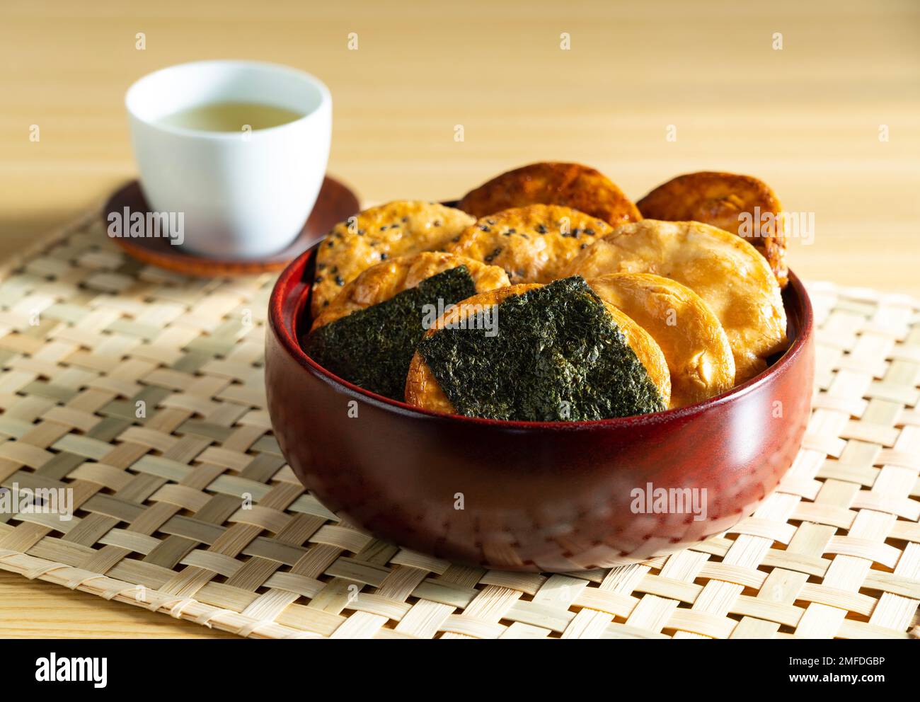 Sembei and green tea on the table. Sembei is a Japanese snack. Japanese image photo. Stock Photo