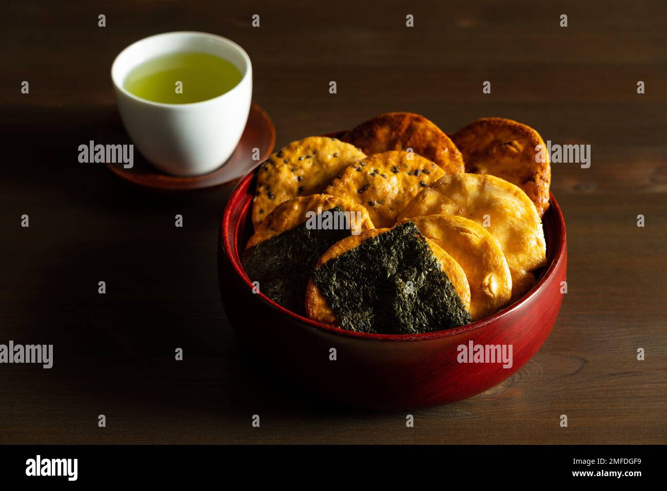 Sembei and green tea on the table. Sembei is a Japanese snack. Japanese image photo. Stock Photo