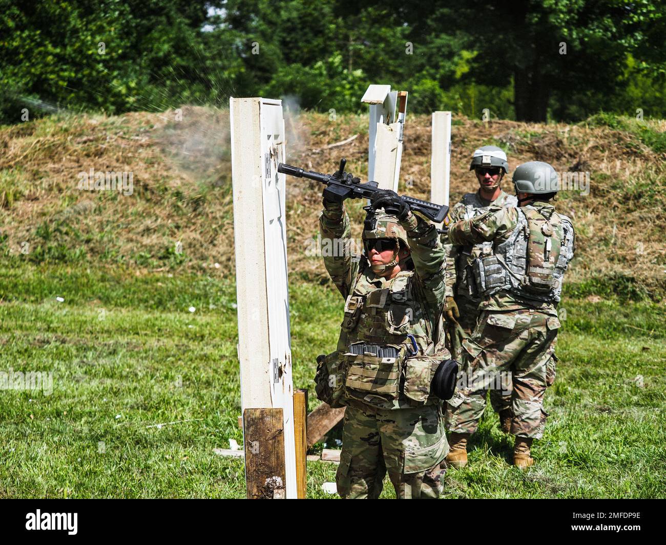 Indiana National Guard Spc. Silvia Rodriquez, a combat engineer with 776th Engineer Battalion, fires a 12-gauge breacher round into a door while practicing breaching techniques at Camp Atterbury, Indiana, Aug. 19, 2022. Army engineers are experts in mobility, counter-mobility, engineering and survival. Stock Photo