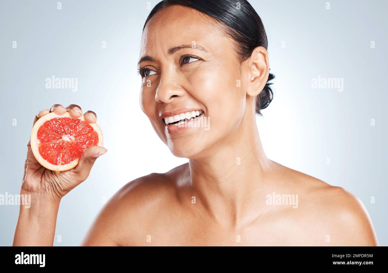 Grapefruit, skincare and woman on studio background for wellness