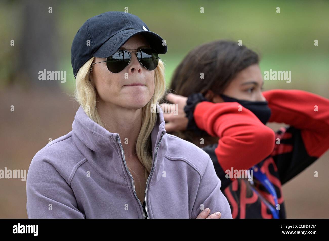 Elin Nordegren, left, and Sam Alexis Woods watch Tiger Woods and Charlie Woods on the 18th hole during the final round of the PNC Championship golf tournament, Sunday, Dec