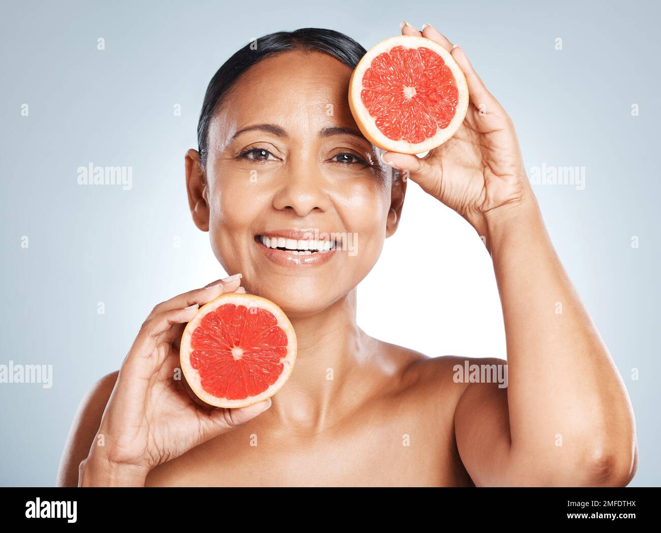 Grapefruit, portrait and vitamin c skincare of happy woman on studio