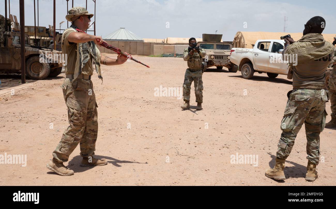 NIGERIEN AIR BASE 201, Niger - U.S. Air Force Senior Airman Eric Milindi, middle, 724th Expeditionary Air Base Squadron civil engineer flight member, de-escalates a simulated hostile situation during the 409th Expeditionary Security Forces Squadron augmentee training at Nigerien Air Base 201 in Niger, Aug. 19. The squadron’s mission is to protect and defend the base, however, in times of increased threat levels or reduced manpower, an augmentee program is needed to fulfill the need for additional personnel to support installation-level force protection requirements. Stock Photo