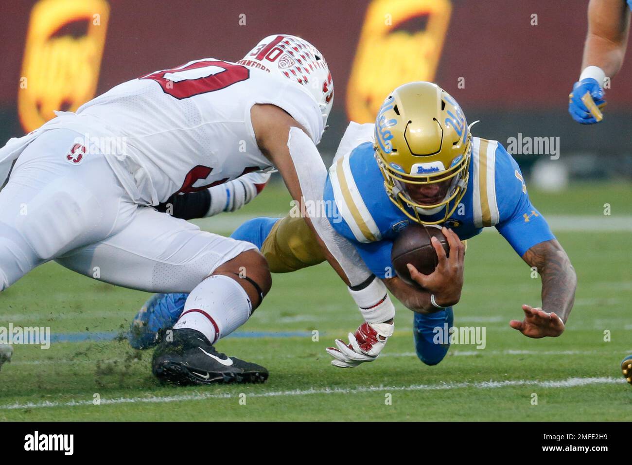 UCLA quarterback Dorian ThompsonRobinson (1) is brought down by