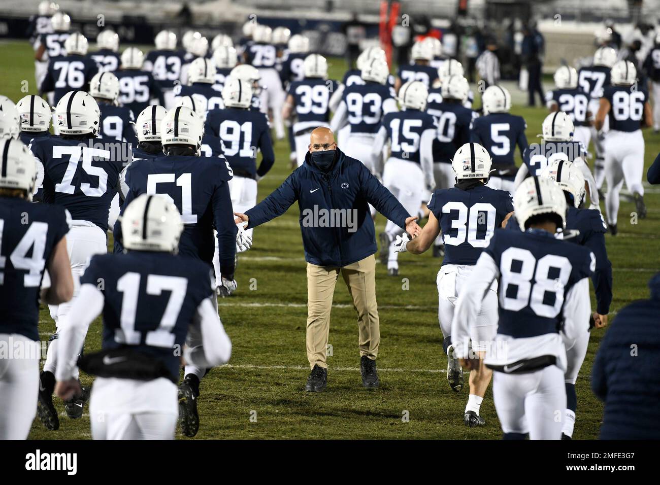 Penn State head coach James Franklin greets his team as they take the field for an NCAA college football game against Illinois in State College, Pa., on Saturday, Dec. 19, 2020. (AP Photo/Barry Reeger) Stock Photo