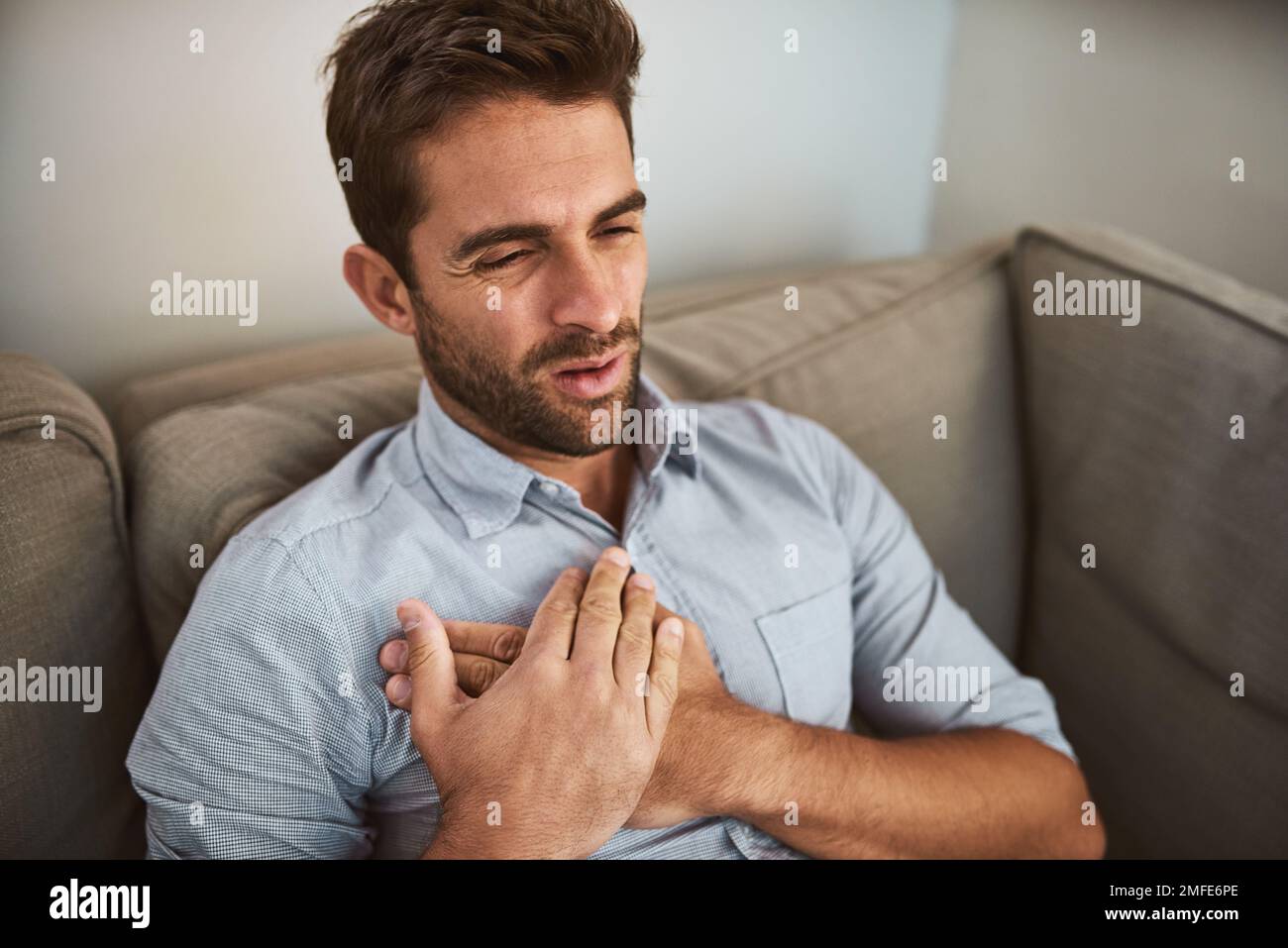 Chest pain is never good. an looking young man holding