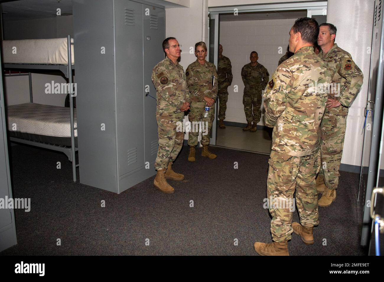 U.S. Air Force Lt. Gen. Jim Slife, left, Commander, Air Force Special Operations Command, is briefed USAF Maj. Gen. Michele Edmondson, right, Commander, 2nd AF, USAF Col. Nathan Colunga, right, Commander, Special Warfare Training Wing, USAF Col. Edmund Loughran, right, Commander, Special Warfare Training Group and USAF Maj. Jesse Galt, right front, director of operations, 350th Special Warfare Training Squadron, on co-ed living quarters, Aug. 19, 2022, Joint Base San Antonio-Chapman Annex, Texas. “Slife visited the SWTW to observe the SWTW pipelines that feed operational AFSOC units and how th Stock Photo