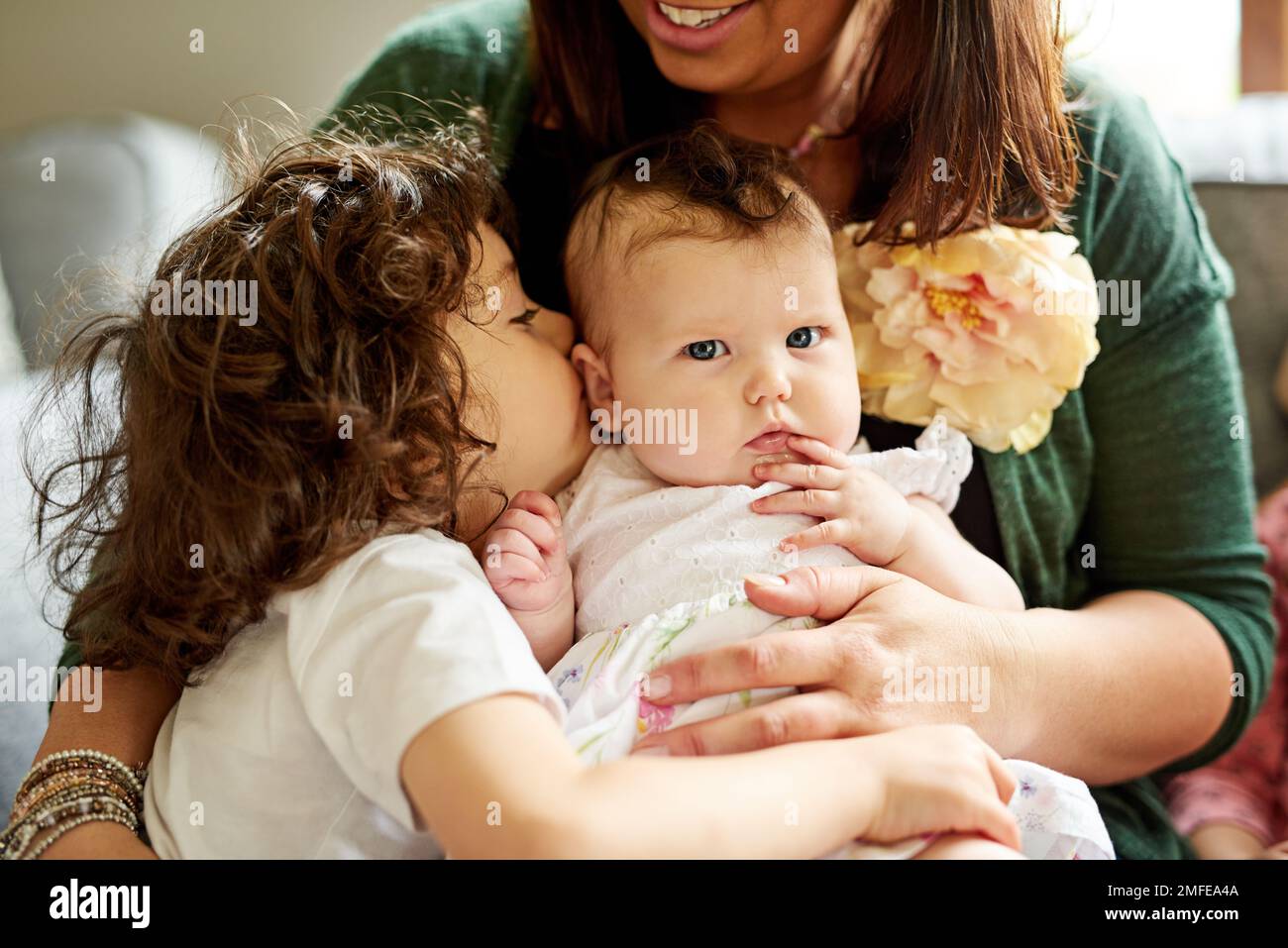 They treasure each other. a little boy bonding with his mother and baby