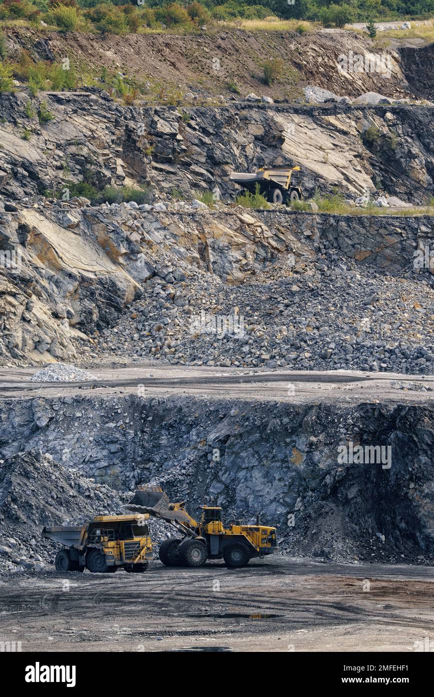 Loading stone with a wheel loader on a dump truck. Stone mining in the ...