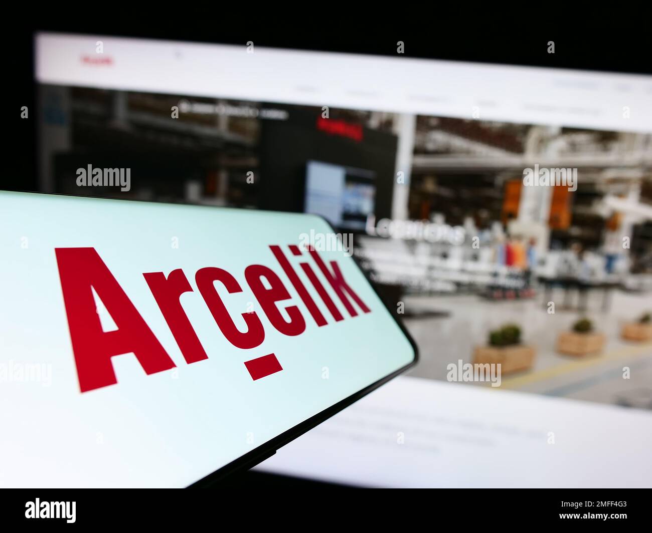 Cellphone with logo of household appliances company Arcelik A.S. on screen in front of business website. Focus on center-left of phone display. Stock Photo