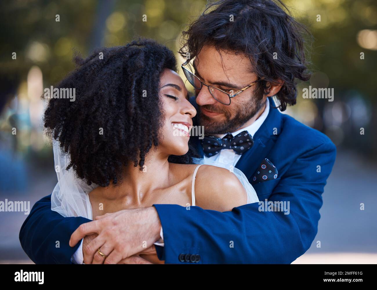 Wedding, couple hug and marriage outdoor with commitment, trust and love with bride and groom in park. Happiness, life partner with married man and Stock Photo
