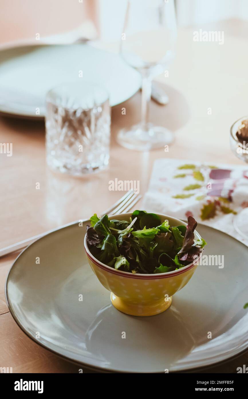 A vertical shot of the modern table setting with delicious healthy salads Stock Photo