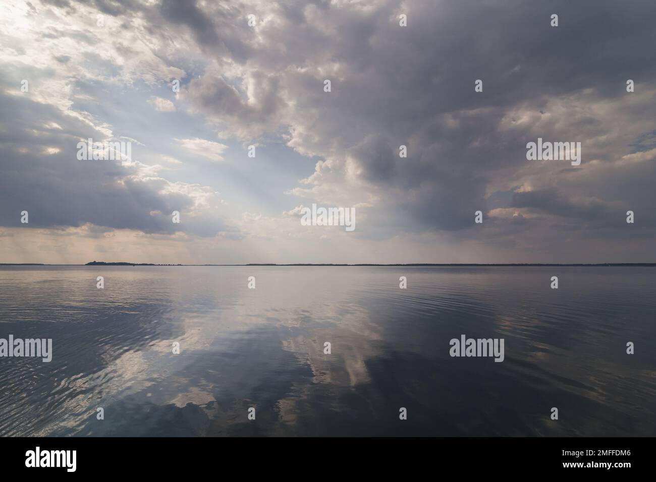 Clouds reflecting on water surface landscape photo Stock Photo - Alamy
