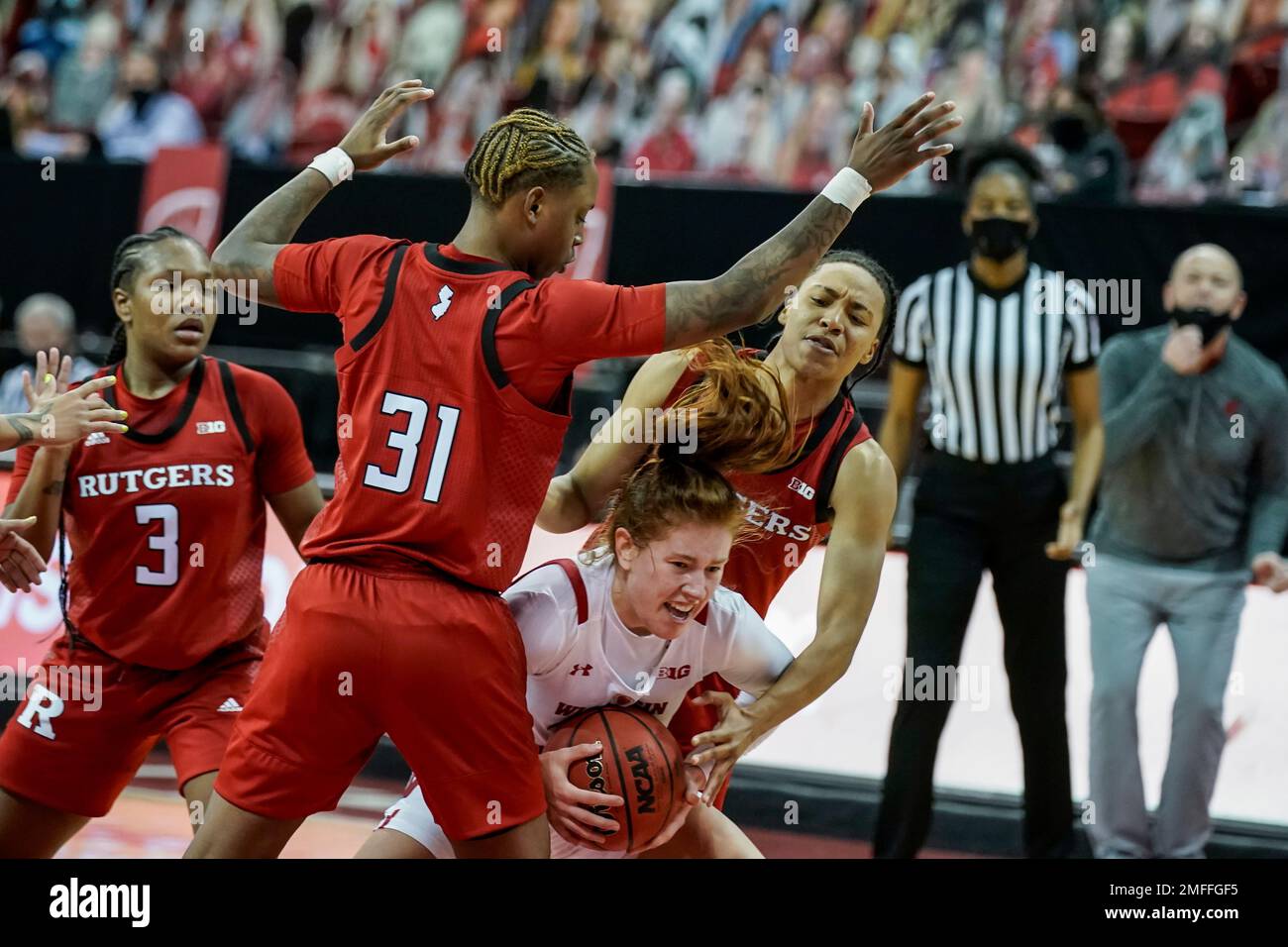 Wisconsin's Sydney Hilliard, center, battles against Rutgers' Tekia